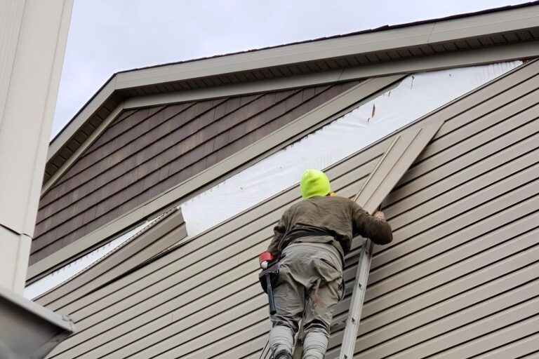 Exterior siding repair in progress by a painter in Andover, KS, preparing damaged areas before painting