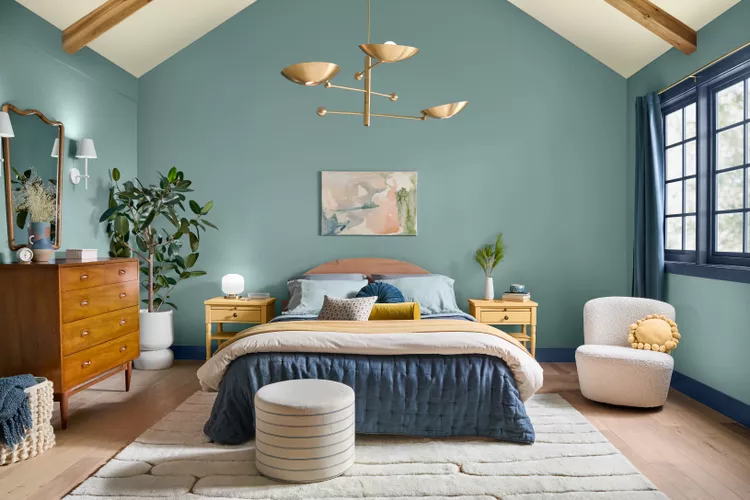 Modern bedroom with soft green walls and warm wood accents by an interior painter in East Lyme, CT